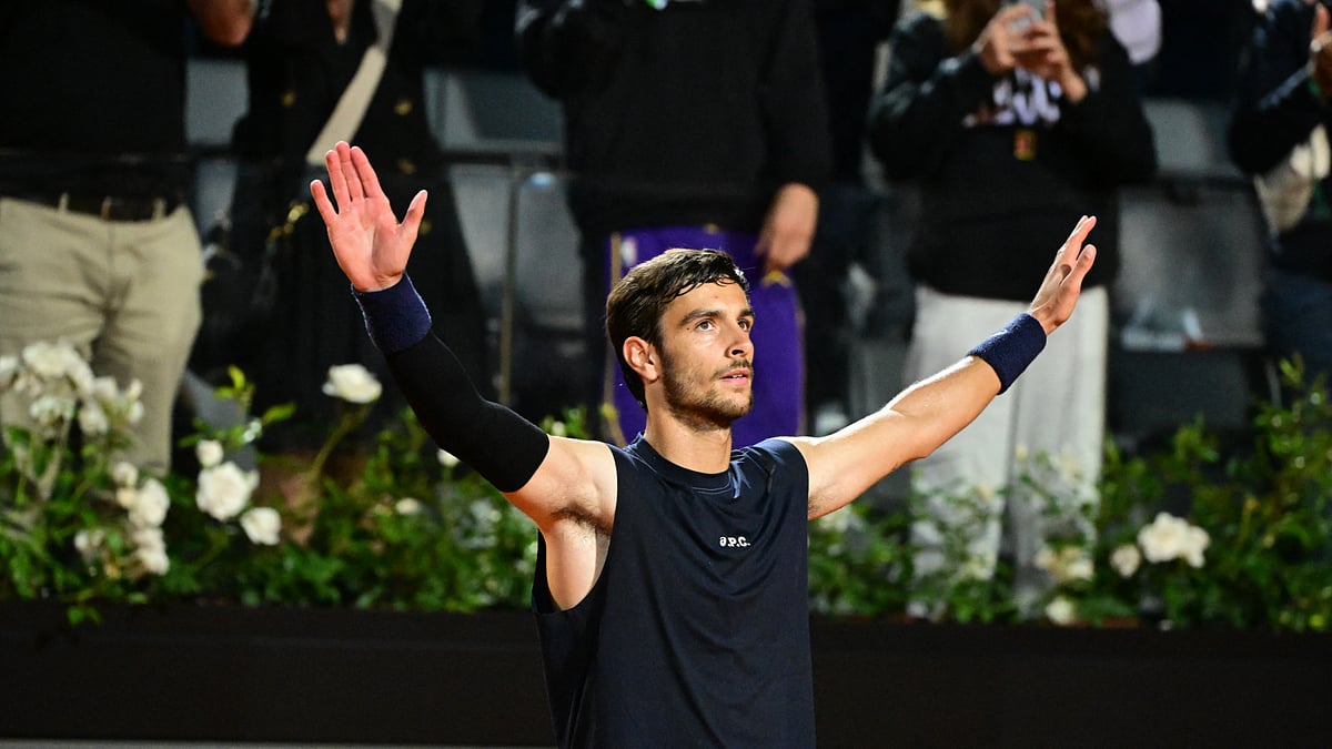 Lorenzo Musetti throws his arms in the air to celebrate Wednesday's win in Rome