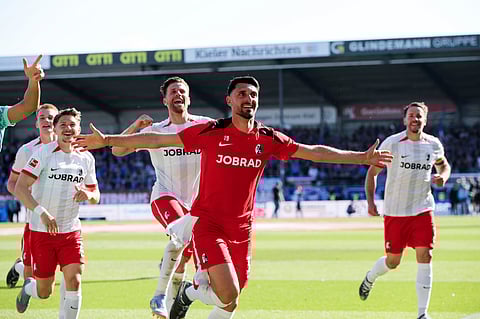 Freiburg's Vincenzo Grifo, front, and his teammates celebrate after their German Bundesliga 2024-25 match against Holstein Kiel in Kiel on Saturday, May 10, 2025.