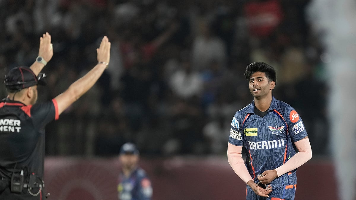 AP Photo/Ashwini Bhatia : Lucknow Super Giants' Mayank Yadav reacts after being hit for a six by Punjab Kings' Prabhsimran Singh during the Indian Premier League cricket in Dharamshala.