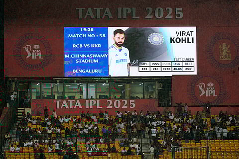 A sign displays a portrait of the great India international and Royal Challengers Bengaluru's player Virat Kohli days after he announced his retirement from the test cricket, before the start of the Indian Premier League cricket match between Kolkata Knight Riders and Royal Challengers Bengaluru at Chinnaswamy Stadium in Bengaluru, India, Saturday, May 17, 2025.
