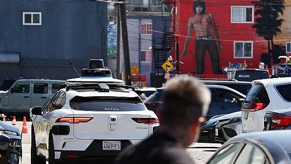 A Waymo autonomous self-driving Jaguar taxi driving near Venice Beach in Los Angeles, California.