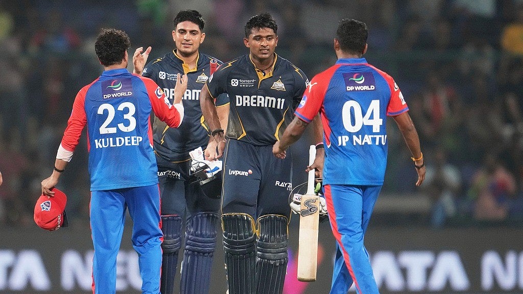 Gujarat Titans' captain Shubman Gill teammate Sai Sudharsan are congratulated by Delhi Capitals' Kuldeep Yadav T. Natarajan after the IPL 2025 match. - | Photo: AP/Manish Swarup