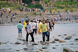 | Photo: AP : Cascading Effect: People cross the Chenab River after the flow of water was halted from a dam at Akhnoor, on the outskirts of Jammu, on May 5, 2025