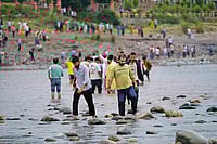 Indus Waters Treaty: Unfair And Outdated | Photo: AP : Cascading Effect: People cross the Chenab River after the flow of water was halted from a dam at Akhnoor, on the outskirts of Jammu, on May 5, 2025
