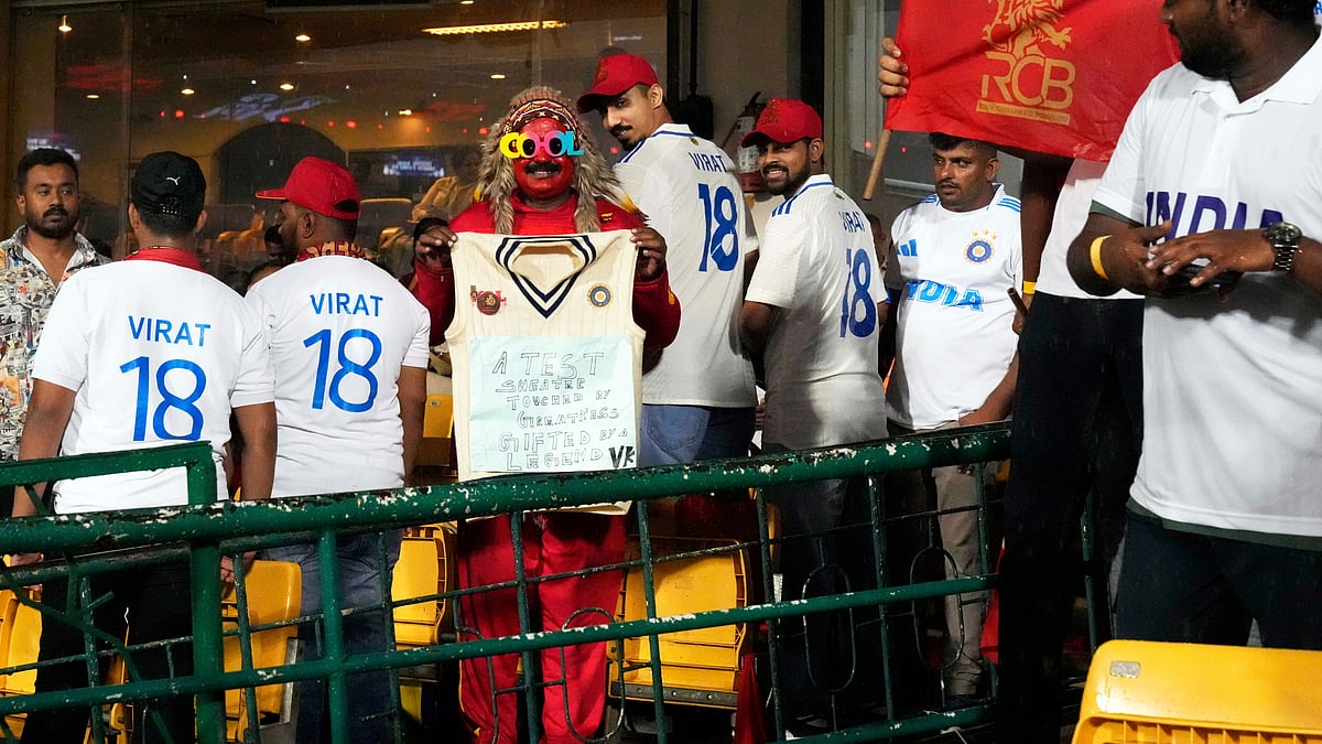(AP Photo/Aijaz Rahi)

 : A fan holds a jersey received from the great India international and Royal Challengers Bengaluru's player Virat Kohli days after he announced his retirement from the test cricket, before the start of the Indian Premier League cricket match between Kolkata Knight Riders and Royal Challengers Bengaluru at Chinnaswamy Stadium in Bengaluru, India, Saturday, May 17, 2025. 
