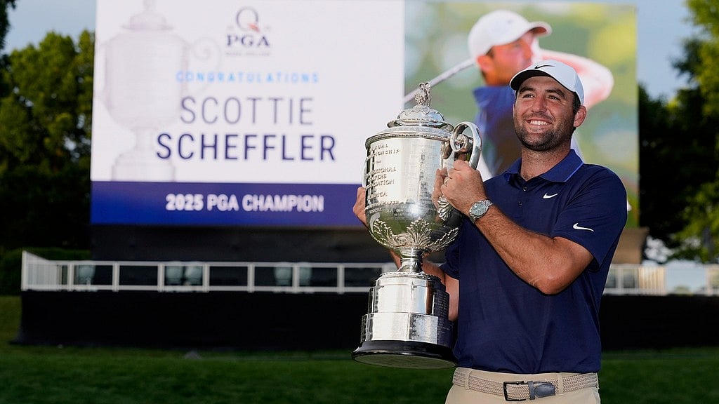 AP/David J. Phillip : Scottie Scheffler poses with the Wanamaker trophy after winning the PGA Championship golf tournament at the Quail Hollow Club, Sunday, May 18, 2025.