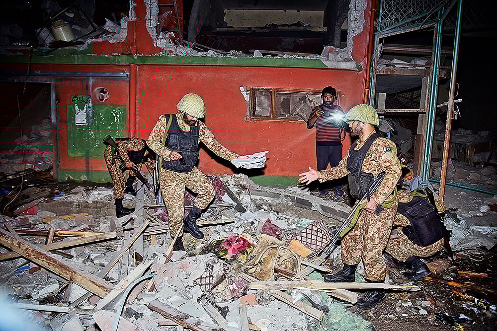 | Photo: AP : Strike Back: Soldiers inspect a building damaged by an Indian missile attack near Muzaffarabad in Pakistan-occupied Kashmir on 
May 7, 2025