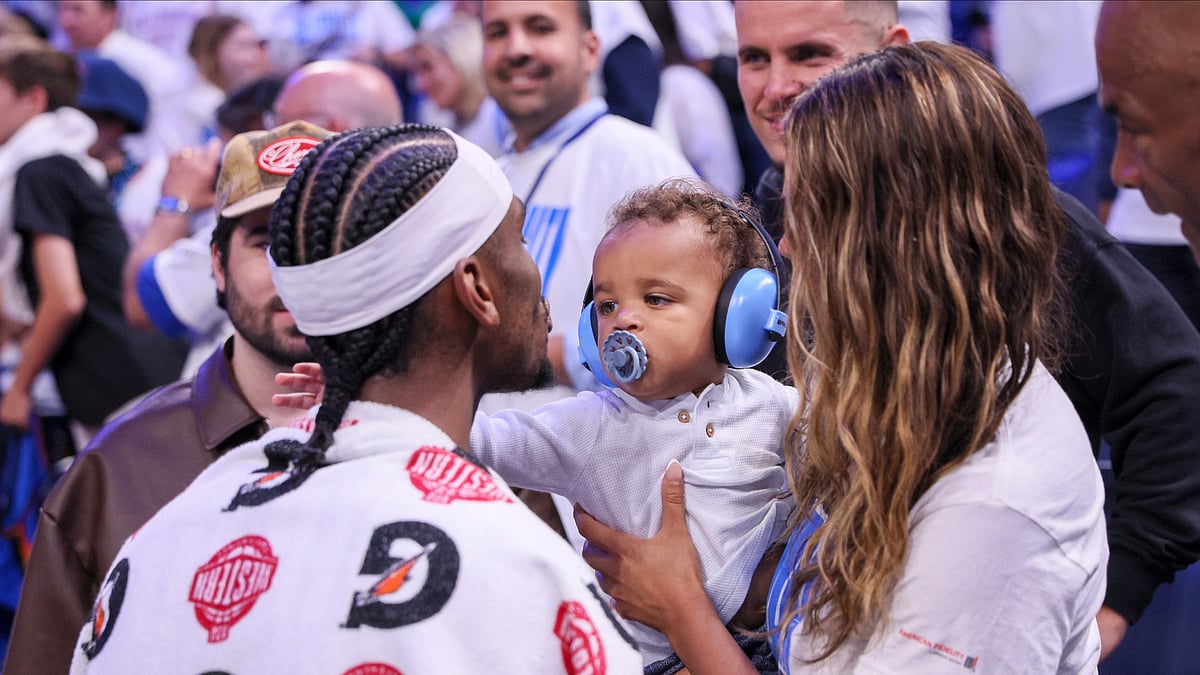 (AP Photo/Nate Billings) : Oklahoma City Thunder guard Shai Gilgeous-Alexander, left, meets with his wife, Hailey Summers, and their son Ares Alexander following Game 1 of an NBA basketball Western Conference Finals playoff series against the Minnesota Timberwolves Tuesday, May 20, 2025, in Oklahoma City. 