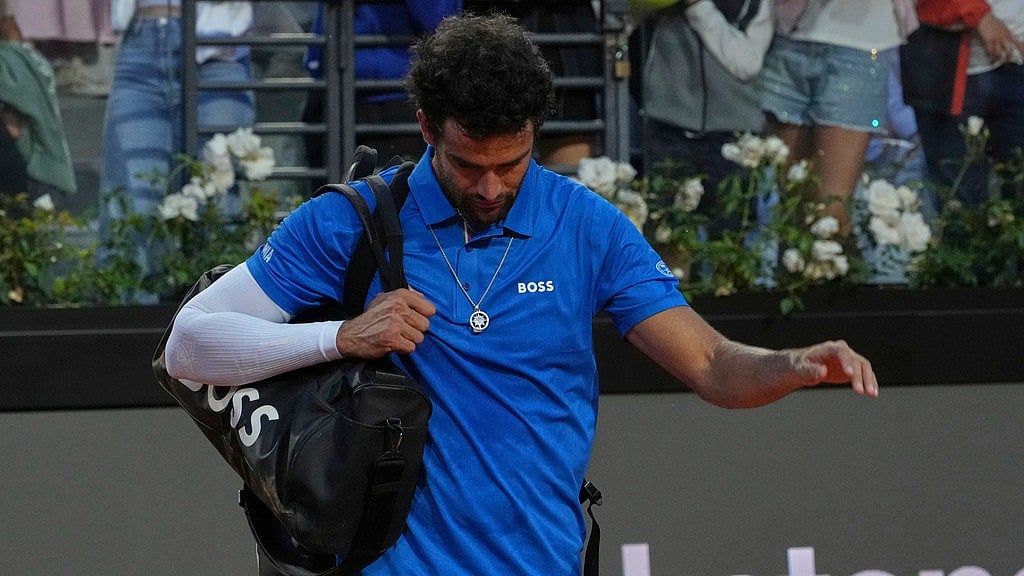 AP : Matteo Berrettini walks off the court following an injury during his match against Casper Ruud, at the Italian Open in Rome.