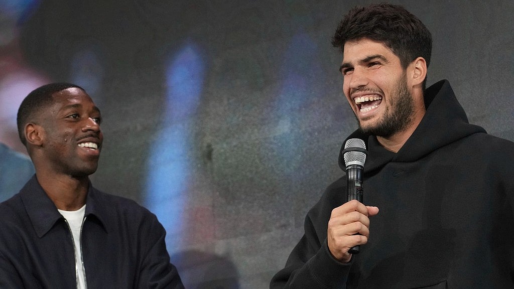French Open defending champion Carlos Alcaraz speaks during the draw ceremony while Paris Saint-Germain star Ousmane Dembele looks on at the Roland Garros stadium in Paris. - AP