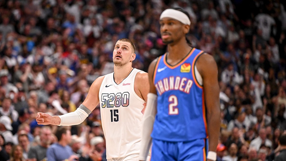 Nikola Jokic (15) of the Denver Nuggets walks behind Shai Gilgeous-Alexander (2) of the Oklahoma City Thunder during the fourth quarter of the Nuggets' 119-107 win at Ball Arena in Denver, Colorado on Thursday, May 15, 2025.