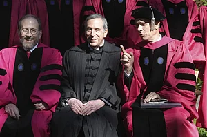 | AP Photo/Steven Senne : Harvard University Provost Alan Garber, left, Harvard President Lawrence Bacow, center, and actor Tom Hanks, right, speak while sitting for a photograph before joining a procession though Harvard Yard at the start of Harvard University commencement exercises, Thursday, May 25, 2023, on the schools campus, in Cambridge, Mass.