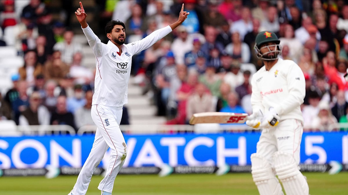 Mike Egerton/PA via AP : England's Shoaib Bashir, left, celebrates taking the wicket of Zimbabwe's Sikandar Raza on day three on day three of the Rothesay International Test match between England and Zimbabwe at Trent Bridge, Nottingham.