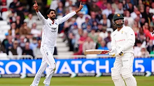 Mike Egerton/PA via AP : England's Shoaib Bashir, left, celebrates taking the wicket of Zimbabwe's Sikandar Raza on day three on day three of the Rothesay International Test match between England and Zimbabwe at Trent Bridge, Nottingham.