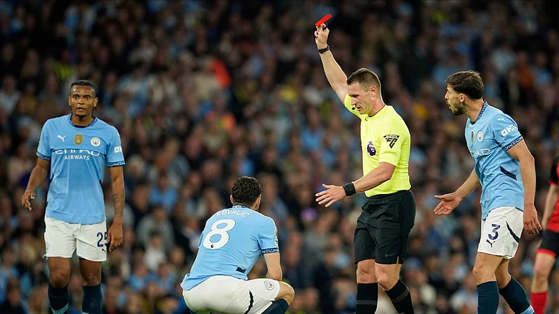 Referee Thomas Bramall shows a red card to Manchester City. AP