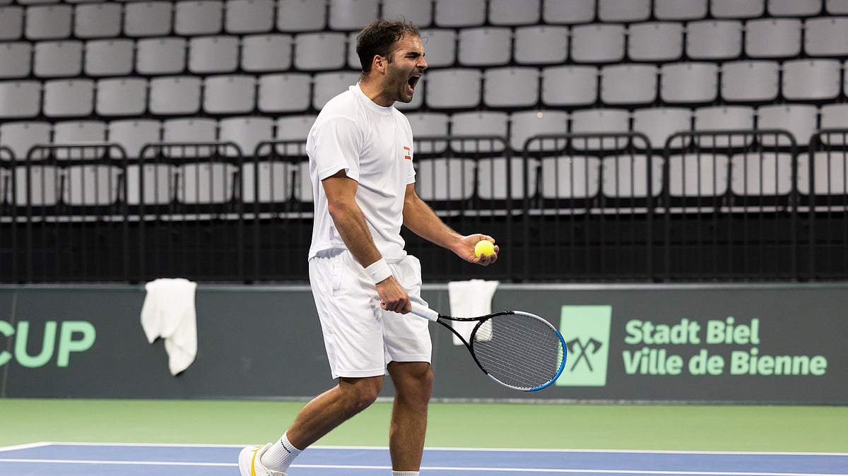 (Peter Klaunzer /Keystone via AP) : FILE - Lebanon's Benjamin Hassan celebrates after winning against Switzerland's Dominic Stricker during the Davis Cup playoff for World Group 1 match in the Swiss Tennis Arena in Biel, Switzerland, Friday, March 4, 2022.