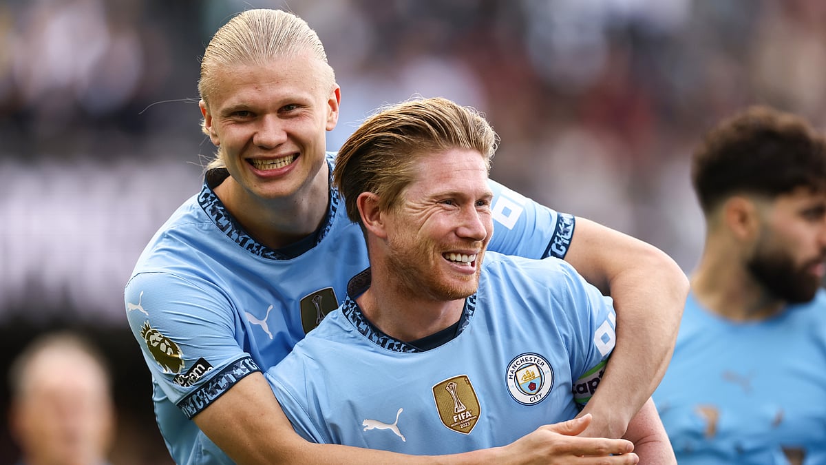Erling Haaland celebrates with Kevin De Bruyne