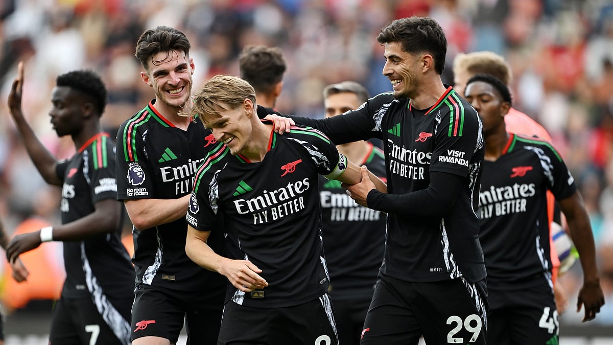 Martin Odegaard celebrates with his teammates.