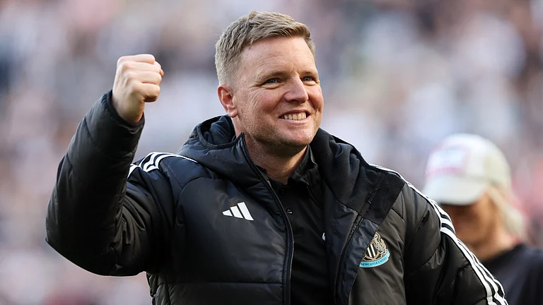 Eddie Howe celebrates achieving Champions League football in front of a jubilant St James' Park. - null