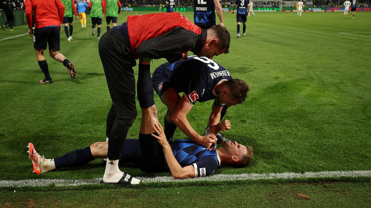 Leo Scienza is mobbed by his team-mates after Heidenheim's win