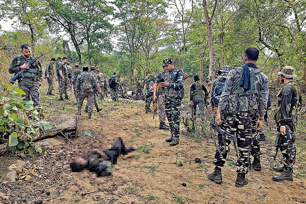 Photo: PTI : Striking Hard: Security personnel at the site where a Maoist commander was killed in Palamu, Jharkhand on May 27