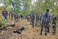 Photo: PTI : Striking Hard: Security personnel at the site where a Maoist commander was killed in Palamu, Jharkhand on May 27