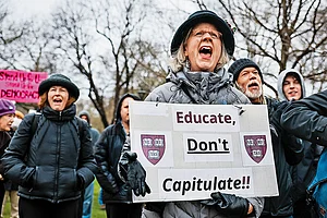 Photo: Getty Images : ‘Educate, Don’t Capitulate!’: A Cambridge protester urging Harvard to resist Trump’s influence on the institution