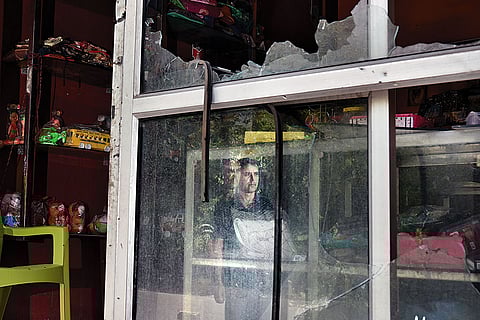 Counting Loses: A man inside his damaged shop in Poonch town