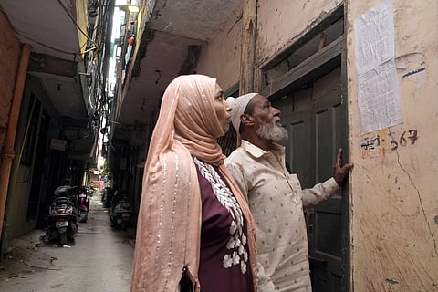 Mohd. Usman looks at the eviction notice stuck outside this house in Khasra No 279, Batla House, Okhla.