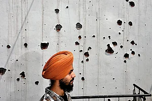 | Photo: Yasir Iqbal : Shattered Lives: A family member of the deceased ex-serviceman, Amarjeet Singh, at their damaged house in Poonch