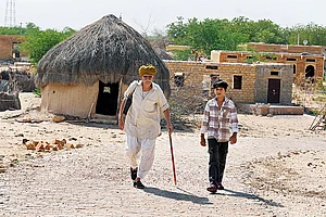 | Photo: Tribhuvan Tiwari : Such a Long Journey: Ranu Lal with his grandson in Myajlar village, located at the edge of the Indian Thar desert border