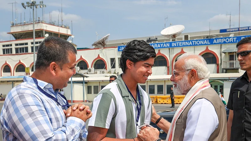 PM Narendra Modi is being greeted by cricketer Vaibhav Suryavanshi. PTI