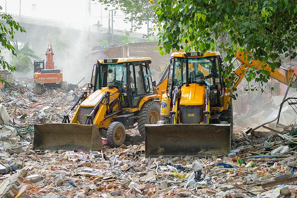 | Photo: PTI : Demolition at Madrasi Camp