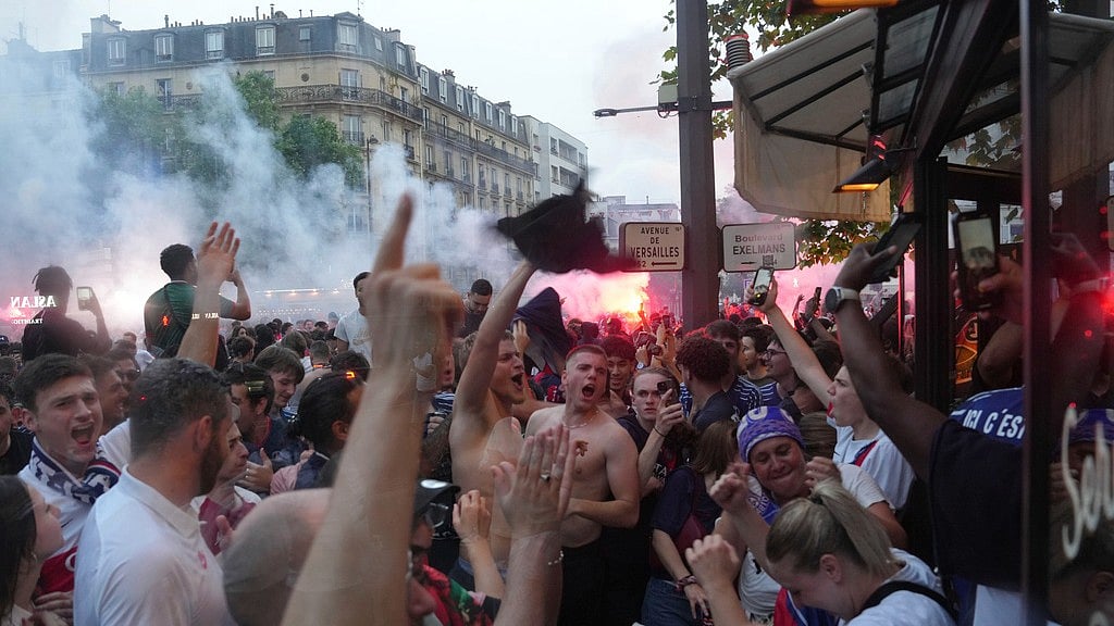 AP : Supporters celebrate a Paris Saint-Germain goal outside a cafe during the Champions League final against Inter Milan.