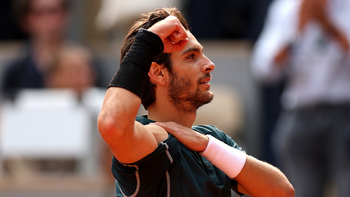 Lorenzo Musetti celebrates his win over Frances Tiafoe.