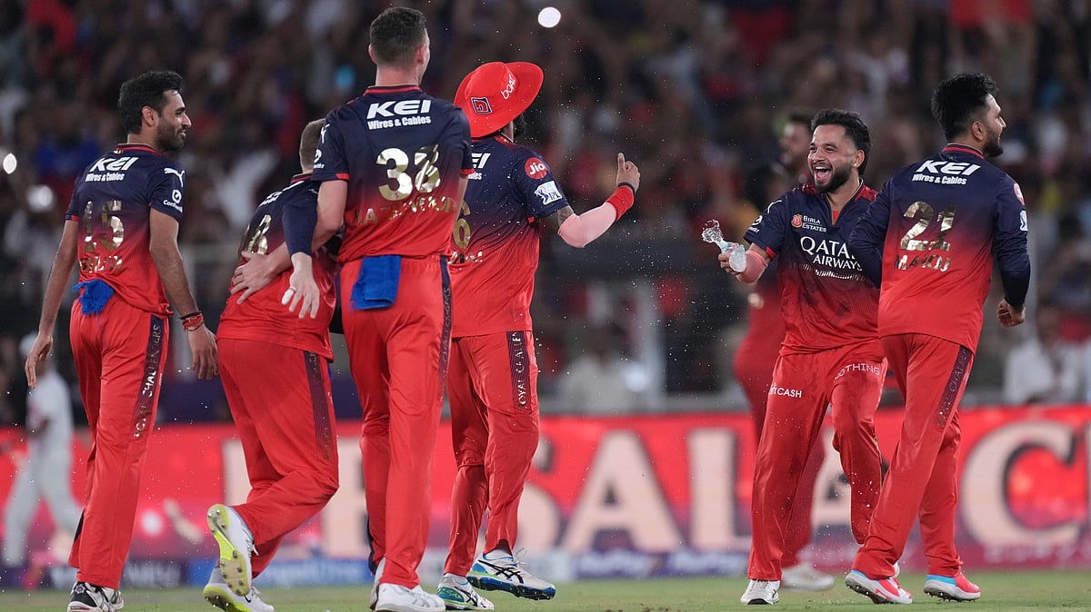 | Photo: (AP Photo/Ajit Solanki) : Royal Challengers Bengaluru players celebrate after their win in the Indian Premier League final cricket match against Punjab Kings at Narendra Modi Stadium in Ahmedabad.