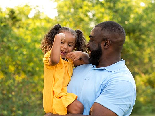 A Foster Father Holding His Daughter In His Arms
