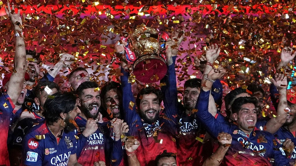 AP : Royal Challengers Bengaluru players celebrate with the winners trophy after their win in the Indian Premier League 2025 final against Punjab Kings at Narendra Modi Stadium in Ahmedabad.