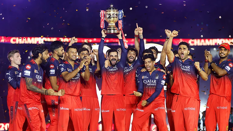 Virat Kohli lifts the trophy as RCB celebrate their maiden IPL title. - null