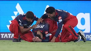 AP Photo/Ajit Solanki : Royal Challengers Bengaluru's Virat Kohli, centre, reacts after their win in the Indian Premier League final cricket match against Punjab Kings at Narendra Modi Stadium in Ahmedabad.