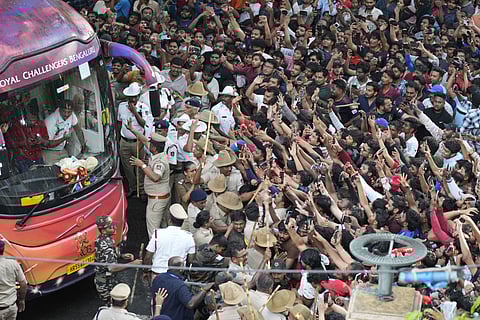 Fans cheer as the bus carrying Royal Challengers Bengaluru cricketers, winners of the Indian Premier League, arrive at the M. Chinnaswamy Stadium in Bengaluru, India, Wednesday, June 4, 2025. (AP Photo/Aijaz Rahi)


