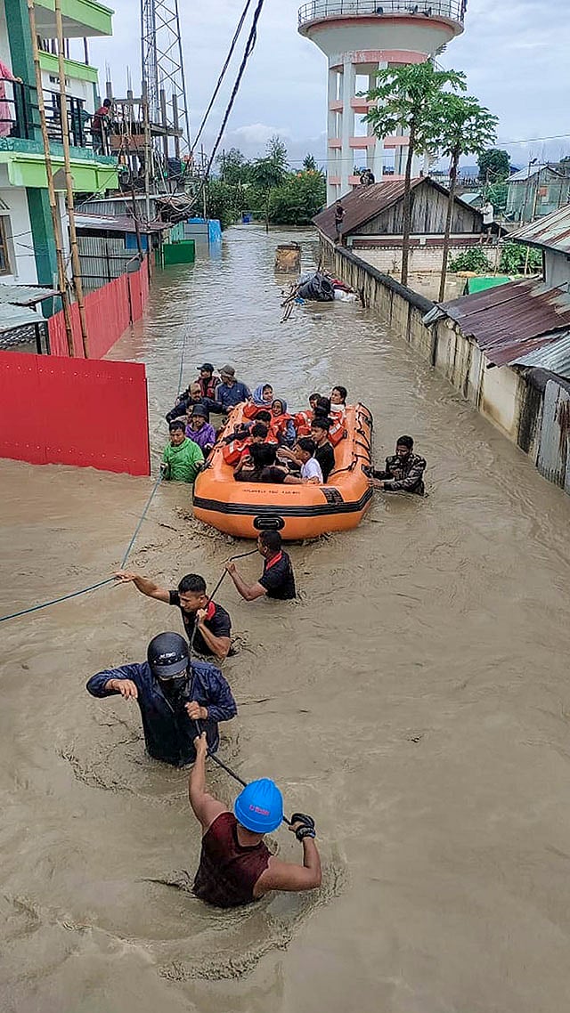 Photo: PTI : People being evacuated from a flood-affected area after heavy rainfall, in Manipur.