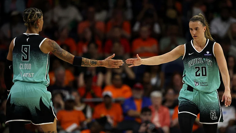 Guard Sabrina Ionescu of the New York Liberty and guard Natasha Cloud of the New York Liberty high-five against the Washington Mystics during the first half at Carefirst Arena on June 5, 2025 in Washington, DC. - null