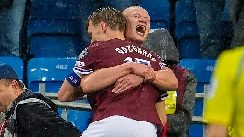 Norways Erling Braut Haaland, right, celebrates