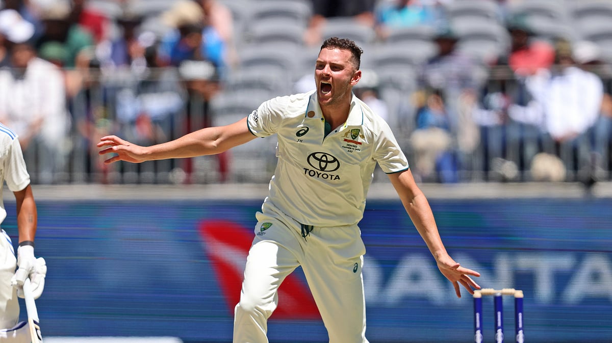 FILE - Australia's Josh Hazlewood, right, reacts after bowling a delivery on the second day of the first cricket test between Australia and India in Perth, Australia, Saturday, Nov. 23, 2024.
 -  (AP Photo/Trevor Collens, File)