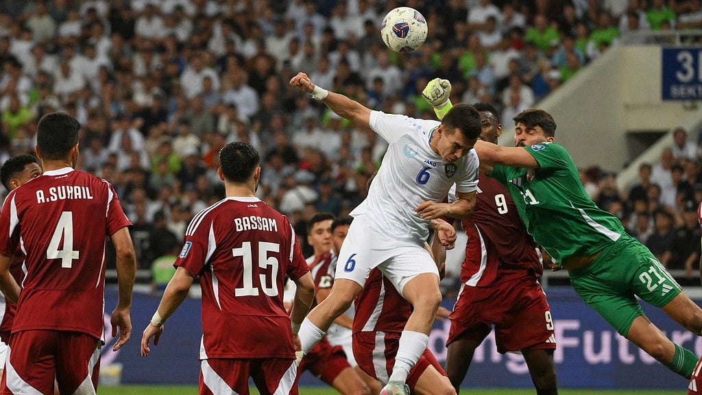 Photo: AP : Uzbekistan's Akmal Mozgovoy, centre, tries to score past Qatar's goalkeeper Salah Zakaria during their FIFA World Cup 2026 qualifying match at the Milliy stadium in Tashkent, Uzbekistan.