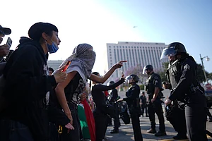 AP/ Eric Thayer : Protesters confront Los Angeles police department personnel in riot gear in downtown Los Angeles on June 9, 2025.