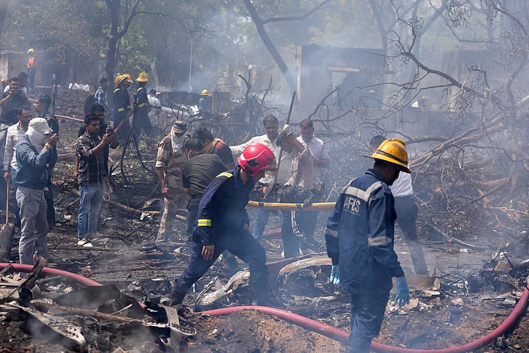 Firefighters at the site of an airplane crash in Ahmedabad on June 12, 2025. - Ajit Solanki/ AP