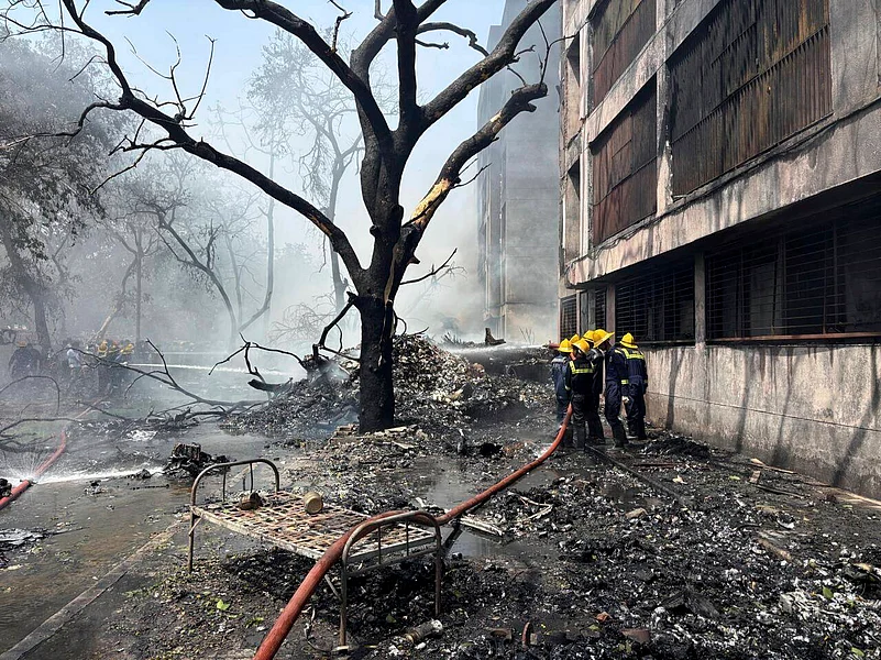 Firefighters at the site of the Boeing Dreamliner crash in Ahmedabad