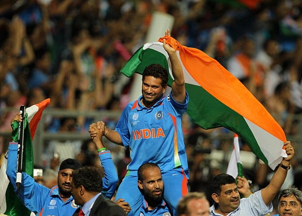 by Manoj Patil/Hindustan Times via Getty Images : MUMBAI, INDIA - APRIL 2: Sachin Tendulkar of India waves the Indian flag after they won the final of 2011 ICC World Cup beating Sri Lanka by 6 wickets to become the World Champions at Wankhede stadium in Mumbai, India on April 2, 2011.